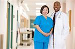 Doctor And Nurse Standing In A Hospital Corridor