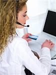 Beautiful business woman using credit card in internet shop