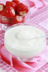 White yogurt in the bowl with strawberries