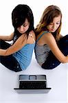 sitting girls looking to laptop on  an isolated white background