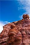 old carvings in red sandstone against a blue sky. picture taken in Petra, Jordan