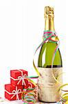 Champagne bottle with gifts, ribbons and confetti for celebrations