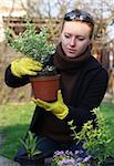 woman with green herbs in garden