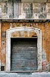 old business in the ghetto neighbourhood in Roma. Wall is dirty and broken