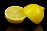 Lemon and lime citrus fruit isolated against a black background