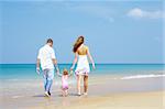 view of young family having fun on the beach