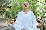 image of young woman practicing yoga in tropic environment