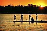 the fishers  silhouette over sunset background