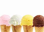 Assorted ice cream in sugar cones on white background