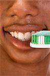 Close up of Afro-American female brushing her teeth