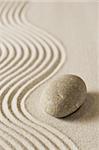 Stone on raked sand; mini rock garden; zen concept