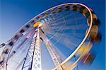 Big wheel on a fun fair with colorful lights. Motion blurred. Long exposure time with tripod.