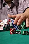 Confident poker player showing big slick and grabbing the pot