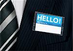 Namebadge saying hello on a well dressed businessman - insert your own information