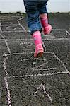 Girl jumps playing hopscotch