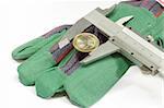 Caliper with one euro coin on gloves as background.