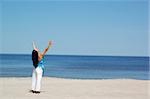 woman doing exercise on the beach