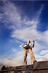 Banjo Player with groovy clothes against a wide sky