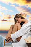 cute young woman sitting in bathroom wearing white bathrobe and kissing her knee