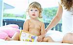 High key portrait  of young baby getting busy with the book