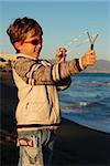 The boy plays on a beach