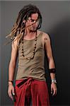 Portrait of young funky male with long dreadlocks