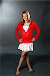 Pretty teenage girl in a red sweater and white mini skirt.