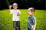 Two Little Kids Playing With Soap Bubbles