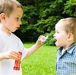 Two Boys Playing With Soap Bubbles