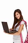 Friendly Asian High school girl student standing in jeans with backpack and holding notebooks and composition book