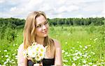Young Woman With Flowers On The Meadow