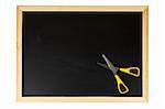 A empty black chalkboard with yellow scissors. Isolated on white background