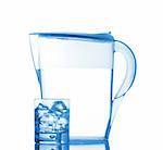 Pitcher and glass with ice cubes of mineral water reflected on white background