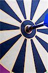 A magnetic dart board with dart(s) at the center (bullseye)