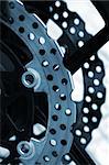 Closeup detail of a racing motorcycle's brake disc.