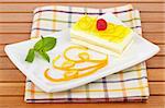 Delicious lemon cake with soft shadow on white dish. Shallow depth of field