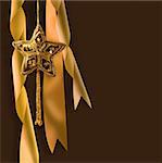 Gold christmas star with ribbons against dark background