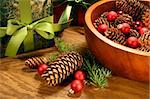 Pine cones , christmas balls and gifts on oak table