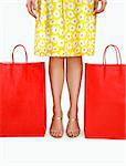 Mid adult Italian woman holding standing betweend shopping bags