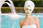 Young woman with facial mask in beauty spa.