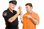 Prisoner offers policeman bribe.  Officer refuses and threatens handcuffs.  Isolated on white.