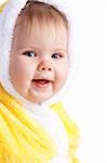 Smiling baby girl in yellow hood, isolated
