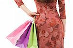 Young woman silhouette with shopping bags isolated on white