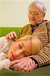 A young woman sleeping on her grandmother's feet - part of a series.