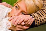 A young woman  laying her head on her grandmother's legs - part of a series.