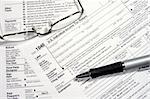 Close-up of a Federal Tax Return Form with glasses and a pen