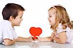 Two happy kids with valentines heart or birthday gift - isolated