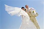 bride and groom on the background of blue sky