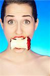 Portrait of beautiful woman with apple core in mouth