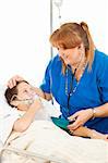 Friendly pediatric nurse comforts a small boy in the hospital.